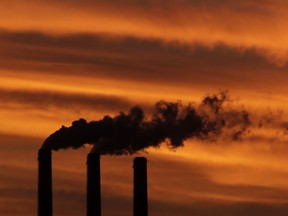 The Northwest Territories has announced it will implement a carbon tax.The N.W.T.'s tax will begin on July 1, 2019, at $20 a tonne. Smoke billows from smokestacks near Emmett, Kansas, on Dec. 2, 2012.
