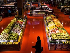 People shop in the produce area at a Loblaws store in Toronto on May 3, 2018. Some consumers have vowed to take their patriotism to the supermarket and buy only made-in-Canada products after the federal government slapped retaliatory tariffs on dozens of U.S. goods as part of an escalating trade war with the country's biggest trading partner. However, avoiding products from south of the border that are on the tariff list is easier said than done, thanks to our integrated economies and the fact that many companies don't clearly label where their products are made.