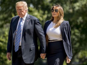 President Donald Trump and first lady Melania Trump arrive on the South Lawn of the White House in Washington, Wednesday, July 18, 2018, after returning from Andrews Air Force Base, where they paid their respects to the family of fallen U.S. Secret Service special agent Nole Edward Remagen who suffered a stroke while on duty in Scotland.