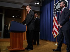 Deputy Attorney General Rod Rosenstein speaks at a news conference at the Department of Justice, Friday, July 13, 2018, in Washington. From left, Assistant Attorney General John Demers, Rosenstein, and Acting Principal Associate Deputy Attorney General Ed O'Callaghan.
