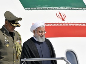 Iranian President Hassan Rouhani, right, arrives at the Zurich airport, in Kloten, Switzerland. Monday, July 2, 2018. Hassan Rouhani is on a two day state visit to Switzerland