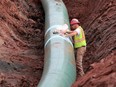 A pipe fitter lays the finishing touches to the replacement of Enbridge Energy's Line 3 crude oil pipeline stretch in Superior, Minn.