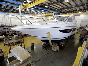 Workers inside this boat apply finishing details at Regal Marine Industries in Orlando, Fla., Wednesday, July 11, 2018. Some U.S. manufacturers are feeling the impact of tariffs of up to 25 percent that the Trump administration has imposed on thousands of products imported from China, Europe, Mexico, Canada, India and Russia, and of retaliatory tariffs that countries have put on U.S. exports. Among the products the U.S. has targeted are aluminum, steel and goods made from those metals, vehicles and their components and computer parts. The retaliation has hit U.S. makers of food and farm products, alcoholic beverages and boats and other vehicles.