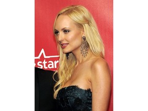 FILE - In this Feb. 10, 2012 file photo, Playboy "bunny" Shera Bechard arrives at the MusiCares Person of the Year gala in Los Angeles. Bechard, a former Playboy centerfold model who claims to have had an affair with a top fundraiser for President Donald Trump, wants him to pay an additional $200,000, beyond a $1.6 million settlement. A redacted copy of Bechard's lawsuit against Elliott Broidy was released Tuesday, July 31, 2018.
