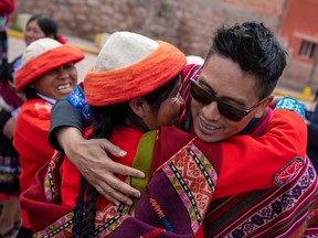 G Adventures founder Bruce Poon Tip meets employees who work at the Ccaccaccollo Women's Weaving Co-op in the Sacred Valley, Peru. About 10,000 travelers a year visit the site.