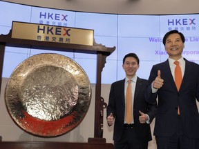 Xiaomi's Founder, Chairman and CEO Lei Jun, right, and Chew Shou Zi, senior vice president and chief financial officer gesture during the listing ceremony at the Hong Kong Stock Exchange in Hong Kong Monday, July 9, 2018.