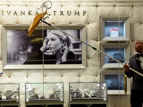 This file photo taken on January 17, 2017 shows a worker cleaning the windows of the Ivanka Trump Boutique at Trump Tower in New York. Trump is shutting down her clothing brand.