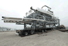 An oversized load is moved onto a specialized barge to cross the Great Lakes.