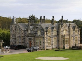 FILE - In this file photo dated Friday Oct. 6, 2017,  a view of MacLeod House, a sixteen room boutique hotel, at the Trump International golf course in Balmedie, Scotland.  After the first phase of development including a championship golf course, clubhouse and hotel, U.S. President Donald Trump's family business has outlined its 150-million-pound (US dollars 196 million) investment plan for the second phase of development of its golf course north of Aberdeen in Scotland.