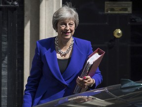 Britain's Prime Minister Theresa May leaves 10 Downing Street in London, bound for the House of Commons to the scheduled Prime Minister's Questions, Wednesday July 18, 2018. May is to visit the border area between Northern Ireland and Ireland during a two-day tour, Downing Street announced Wednesday.