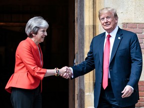 U.S. President Donald Trump and Britain's Prime Minister Theresa May shake hands upon Trump's arrival for a meeting at Chequers, the prime minister's country residence, near Ellesborough, northwest of London on July 13, 2018. Trump launched an extraordinary attack on May's Brexit strategy, plunging the transatlantic "special relationship" to a new low as they prepared to meet Friday on the second day of his tumultuous trip to Britain.