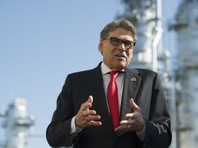 Secretary of Energy Rick Perry stands with the main cyrogenic heat exchange as he speaks with reporters at Dominion Energy's Cove Point LNG liquefaction Project facility in Lusby, Md., Thursday, July 26, 2018. The completion of the facilities export expansion project makes it just the second LNG export facility in the U.S.