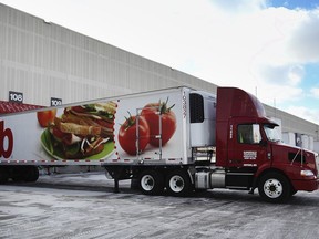 In this Jan. 23, 2013 photo, trailers line up at the loading docks at the Supervalu distribution center in Hopkins, Minn. United Natural Foods is buying Supervalu for $1.26 billion, creating a grocery food wholesaler with a diverse customer base. United Natural Foods of Providence, R.I., said Thursday, July 26, 2018, it's paying $32.50 per share in cash, or a premium of 67 percent, for each share of Supervalu Inc. Including the assumption of debt, the deal is valued at nearly $3 billion.