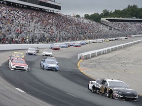 Aric Almirola (10) races ahead of Paul Menard, top left, and Kevin Harvick during the NASCAR Cup Series auto race Sunday, July 22, 2018, at New Hampshire Motor Speedway in Loudon, N.H.