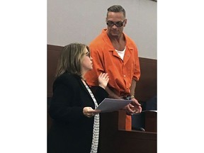 FILE - In this Aug. 17, 2017, file photo, Nevada death row inmate Scott Dozier, right, confers with Lori Teicher, a federal public defender involved in his case, during an appearance in Clark County District Court in Las Vegas. Dozier is slated to die by a three-drug lethal injection combination never before tried in any state and has said repeatedly he wants his sentence carried out and he doesn't care if it's painful.