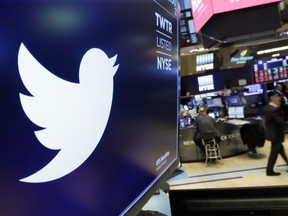 FILE - In this Feb. 8, 2018 file photo, the logo for Twitter is displayed above a trading post on the floor of the New York Stock Exchange.  Twitter Inc., on Friday, July 27 reported second-quarter net income of $100.1 million, after reporting a loss in the same period a year earlier.  On a per-share basis, the San Francisco-based company said it had net income of 13 cents. Earnings, adjusted for one-time gains and costs, were 17 cents per share.