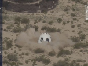 In this image from video made available by Blue Origin, the company's New Shepard capsule lands during a test in West Texas on Wednesday, July 18, 2018. Once its booster separated, the capsule's escape motor fired, lifting the spacecraft to 74 miles (119 kilometers) as part of a safety system intended to save lives once customers _ including space tourists _ climb aboard for suborbital hops. (Blue Origin via AP)