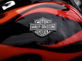 FILE- This April 27, 2017, file photo shows the Harley-Davidson name on the gas tank of a bike in Glenview, Ill. Harley-Davidson topped Wall Street expectations again on steady sales in Latin America, Europe, Middle East and Africa, though shipments slipped by 11 percent in the second quarter and the company warned that new EU tariffs would pressure operating margins.