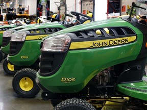 FILE - In this March 23, 2015, file photo, John Deere lawn tractors are on display at a Home Depot in Robinson Township, Pa. Wall Street is flooding into the agricultural sector on reports that the Trump administration is preparing a plan that would send billions in aid to U.S. farmers hurt by tariffs. CF Industries Holding and Mosaic Company both traded up more than 3 percent, while Deere & Co. shot up more than 4 percent after news of the aid package was leaked to The Associated Press by two people briefed on the plan.