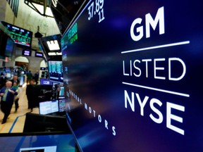 FILE - In this April 23, 2018, file photo, the logo for General Motors appears above a trading post on the floor of the New York Stock Exchange. General Motors, facing rising commodity costs in a trade showdown with Europe and elsewhere, cut its outlook for the year. Shares tumbled more than 5 percent before the opening bell, and GM's view of the year ahead dragged down shares of the entire auto sector Wednesday, July 25.