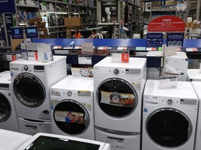 FILE- This May 21, 2018, file photo shows a row of washing machines for sale at Lowe's Home Improvement store in East Rutherford, N.J. The Commerce Department releases its June report on durable goods on Thursday, July 26.
