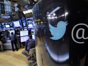 FILE - In this Oct. 13, 2015, file photo, the Twitter logo appears on a phone post on the floor of the New York Stock Exchange. Twitter shares fell Thursday, July 26, 2018, after President Donald Trump said in a tweet the company was limiting visibility of prominent Republicans and said he was going to look into the matter.