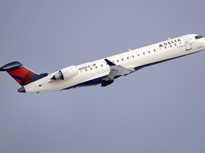 FILE- In this Jan. 8, 2018, file photo, a Delta Air Lines Connection regional jet operated by GoJet Airlines takes off from Logan International Airport in Boston. Delta Air Lines reports earns on Thursday, July 12.