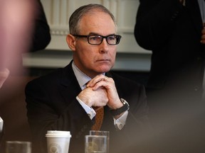 FILE- In this June 21, 2018, file photo, Environmental Protection Agency administrator Scott Pruitt listens as President Donald Trump speaks during a cabinet meeting at the White House in Washington. Pruitt, a former Oklahoma state senator and two-term Republican attorney general, resigned suddenly Thursday, July 5, amid ethics investigations, including ones examining his lavish spending on first-class airline seats and a $43,000 soundproof booth for making private phone calls.