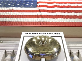FILE- In this May 17, 2018, file photo, an American flag hangs above the bell podium on the floor of the New York Stock Exchange. The U.S. stock market opens at 9:30 a.m. EDT on Monday, July 16.