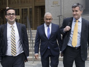 Alain Kaloyeros, center, a former president of the State University of New York's Polytechnic Institute, leaves Federal court where he is on trial on corruption charges, Wednesday, July 11, 2018, in New York. The case involves Kaloyeros and four developers charged with bid-rigging in Gov. Andrew Cuomo's "Buffalo Billion" revitalization program.