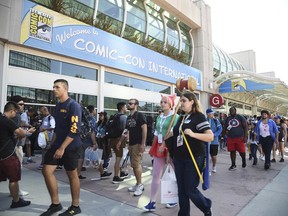 FILE - In this Thursday, July 20, 2017, file photo, guests attend the first day of Comic-Con International in San Diego. More than 130,000 pop culture devotees are descending on San Diego's Gaslamp District, Wednesday, July 18, 2018, for the annual four-day comic book convention Comic-Con. And without Marvel Studios, HBO and Star Wars at the convention, other brands have a unique opportunity to pop.