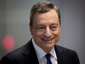 President of European Central Bank Mario Draghi is on his way to a news conference after a meeting of the ECB governing council in Frankfurt, Germany, Thursday, July 26, 2018.