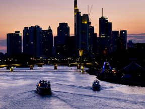 A party ship, left, cruises on the river Main in Frankfurt, Germany, late Saturday, July 28, 2018.