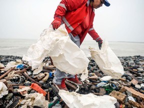 Groups of volunteers clean up plastic waste on a beach in Lima, during the World Environment Day on June 5, 2018.
