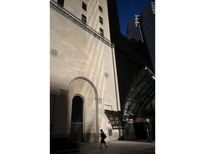 None of Canada's TSX 60 companies were headed by a woman and two-thirds did not include a single woman among top earners during their latest fiscal year, reveals a Canadian Press analysis of corporate Canada's highest ranks. A woman walks through Toronto's financial district on Monday, July 30, 2018.