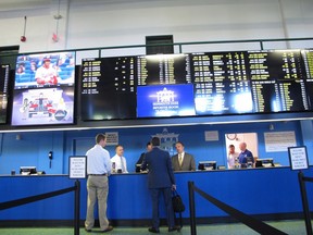 This June 14, 2018 photo shows staff at Monmouth Park racetrack in Oceanport N.J. preparing to begin taking sports bets moments before it became legal in New Jersey. State gambling regulators on Thursday July 12, 2018 were to reveal how the state's sports betting market did in its first two weeks.