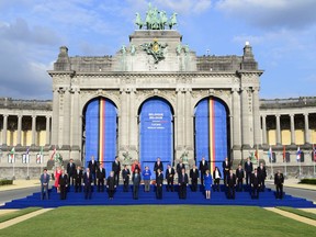 Prime Minister Justin Trudeau, left, takes part in the family photo at Place du Cinquantenaire during the NATO Summit in Brussels, Belgium, on Wednesday, July 11, 2018.