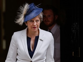 Theresa May, U.K. prime minister, departs following a cabinet meeting at number 10 Downing Street in London, U.K., on Tuesday, July 10, 2018. May looked likely to survive any attempt to oust her over the government's Brexit strategy for now, and is leaning on the biggest opposition party to help get the plan through parliament and counter a mutiny by a group of her own lawmakers.