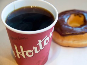 A coffee and donut from Tim Hortons is seen at a Coquitlam B.C., location on April 26, 2018. Tim Hortons has signed an exclusive master franchise joint venture agreement with Cartesian Capital Group to develop and open more than 1,500 Tim Hortons restaurants throughout China over the next 10 years.