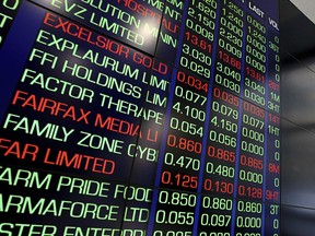 Market trading boards are seen at the Australian Stock Exchange (ASX) center in Sydney, Thursday, July 26, 2018. Australian media companies Nine Entertainment and Fairfax Media have announced plans to merge, with the new media giant to be known only as Nine.