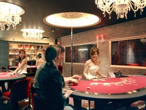 In this July, 2014, photo, restaurant guests enjoy Casino-style display at Jack & Queen restaurant in Osaka. Japan's parliament has approved a contentious casino implementation law on Friday, July 20, 2018, clearing the way for casinos to open in this wealthy nation and possibly lure more foreign visitors. (Kyodo News via AP)