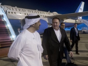 Secretary of State Mike Pompeo, center, is greeted by United Arab Emirates Foreign Minister Sheikh Abdullah bin Zayed Al Nahyan, left, as he arrives at Abu Dhabi International Airport in Abu Dhabi‎, United Arab Emirates, Monday, July 9, 2018.