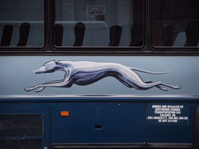 The Greyhound logo is seen on one of the company's buses, in Vancouver, on Monday July 9, 2018. Greyhound Canada says it is ending its passenger bus and freight services in Alberta, Saskatchewan and Manitoba, and cancelling all but one route in B.C. -- a U.S.-run service between Vancouver and Seattle. As a result, when the changes take effect at the end of October, Ontario and Quebec will be the only regions where the familiar running-dog logo continues to grace Canadian highways.