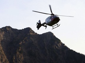 FILE - In this July 6, 2015, file photo a helicopter transports an injured woman to a hospital near the Big Four trail head in Verlot, Wash. Air ambulances transport around 400,000 people each year in the U.S., according to industry estimates. Most trips are from one hospital to another. But they also play a vital role in getting seriously injured or ill people fast help during what doctors call "the golden hour," the initial window after an accident when a patient's chances for recovery are better