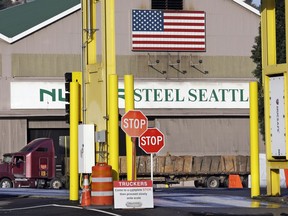 FILE - In this Feb. 25, 2016 file photo, a truck carries a load at the Nucor Steel plant in Seattle. U.S. companies pursuing exemptions from President Donald Trump's tariff on imported steel are accusing American steel manufacturers of spreading inaccurate and misleading information, and they fear it may torpedo their requests. The president of one company calls objections raised by U.S. Steel and Nucor to his waiver request "literal untruths."