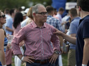 Environmental Protection Agency Administrator Scott Pruitt stands on the South Lawn during an afternoon picnic for military families at the White House, Wednesday, July 4, 2018, in Washington. President Donald  President Trump tweeted Thursday, July 5, he has accepted resignation of Pruitt.