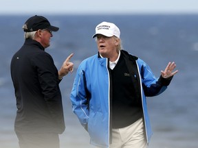 FILE - In this Aug. 1, 2015, file photo, then-presidential hopeful Donald Trump poses for the media during the third day of the Women's British Open golf championship on the Turnberry golf course in Turnberry, Scotland. Trump returns to Scotland, yet again mixing statecraft and business promotion. Trump has a long and fraught history with the country where his mother grew up, betting big on two golf courses that have been losing money.