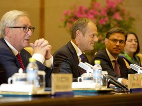 European Commission President Jean-Claude Juncker, left and European Council President Donald Tusk, second from left meet Chinese President Xi Jinping, unseen during a meeting at the Diaoyutai State Guesthouse in Beijing, China, Monday, July 16, 2018.