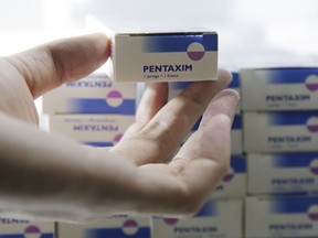A clinic staff shows a box of Pentaxim vaccine for infants at a children's clinic in Hong Kong, Tuesday, July 24, 2018, as they see a rise in the number of mainland parents bringing their children to Hong Kong for vaccinations after the vaccine scandal in China. Chinese leaders are scrambling to shore up public confidence and oversight of the pharmaceutical industry after a rabies vaccine maker was found faking records, the latest in a slew of public health and safety scandals that have outraged Chinese parents.