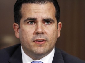 FILE - In this Nov. 14, 2017 file photo, Puerto Rico Gov. Ricardo Rossello, left, speaks during a Senate Committee on Energy and Natural Resources hearing on hurricane recovery, on Capitol Hill in Washington. Puerto Rico's governor said in a statement Thursday, July 5, 2018 he will sue a federal control board to resolve budget differences as the U.S. territory battles an 11-year recession.
